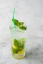 Glass with classic mojito cocktail with lemon and mint, cold refreshing drink or beverage with ice on bright marble background. Royalty Free Stock Photo