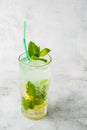 Glass with classic mojito cocktail with lemon and mint, cold refreshing drink or beverage with ice on bright marble background. Royalty Free Stock Photo