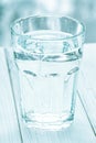 Glass of water with half full water on the table, concept of positive and negative thinking Royalty Free Stock Photo