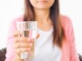 A glass of clean mineral water in woman`s hands. Royalty Free Stock Photo