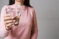 A glass of clean mineral water in woman`s hands. Concept of environment protection, healthy drink and healthcare Royalty Free Stock Photo