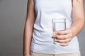 A glass of clean mineral water in woman`s hands. Concept of environment protection, healthy drink and healthcare Royalty Free Stock Photo