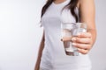 A glass of clean mineral water in woman`s hands. Concept of environment protection, healthy drink and healthcare Royalty Free Stock Photo