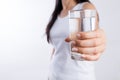 A glass of clean mineral water in woman`s hands. Concept of environment protection, healthy drink and healthcare Royalty Free Stock Photo