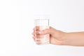 A glass of clean mineral water in woman`s hands. Concept of environment protection, healthy drink and healthcare Royalty Free Stock Photo