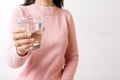 A glass of clean mineral water in woman`s hands. Concept of environment protection, healthy drink and healthcare Royalty Free Stock Photo