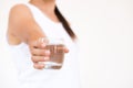 A glass of clean mineral water in woman`s hands. Royalty Free Stock Photo