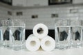 A glass of clean water with osmosis filter and cartridges on white table in a kitchen interior. Concept Household filtration