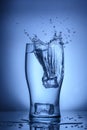 a glass of clean water into which an ice cube was thrown, water splashes 2 Royalty Free Stock Photo