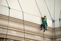 Glass cleaner abseiling from a tall building. Royalty Free Stock Photo