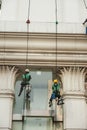 Glass cleaner abseiling from a tall building.