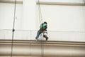 Glass cleaner abseiling from a tall building. Royalty Free Stock Photo