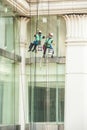 Glass cleaner abseiling from a tall building.