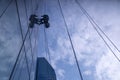 The glass cleaner on the business building. Royalty Free Stock Photo