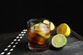 Glass of cocktail with cola, ice and cut lime on table Royalty Free Stock Photo