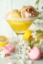 Glass of cocktail, ingredients and flowers against wooden background Royalty Free Stock Photo