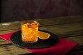 Glass of the cocktail negroni on a old wooden board. Drink with gin, campari martini rosso and orange, an italian cocktail, an Royalty Free Stock Photo