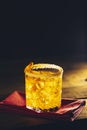 Glass of the cocktail negroni on a old wooden board. Drink with gin, campari martini rosso and orange, an italian cocktail, an Royalty Free Stock Photo