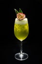 Cocktail with passion fruit  maracuya  and isolated on black background Royalty Free Stock Photo