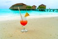 Glass of cocktail is on sandy coral beach, Maldives, The Indian Royalty Free Stock Photo