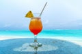 Glass of cocktail is on sandy coral beach, Maldives, The Indian Royalty Free Stock Photo