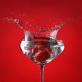 Glass with cocktail and splashing strawberry Royalty Free Stock Photo