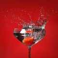 Glass with cocktail and splashing strawberry Royalty Free Stock Photo