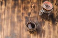 Glass of cofee with cofee beans. Top view and copy space. Cup of black coffee in a glass and grains in a glass jar on a wooden Royalty Free Stock Photo