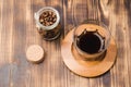 Glass of cofee with cofee beans. Top view. Cup of black coffee in a glass and grains in a glass jar on a wooden table Royalty Free Stock Photo