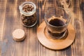 Glass of cofee with cofee beans. Top view. Cup of black coffee in a glass and grains in a glass jar on a wooden table Royalty Free Stock Photo