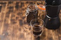 Glass of cofee with coffee beans. Top view. ÃÂ¡up of black coffee in a glass and grains in a glass jar with a coffee maker on a Royalty Free Stock Photo