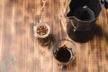 Glass of cofee with coffee beans. Top view. ÃÂ¡up of black coffee in a glass and grains in a glass jar with a coffee maker on a Royalty Free Stock Photo