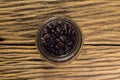 Glass of coffee beans.wooden background