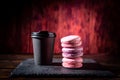 Glass of coffee and cookies. Black glass and red cookies. Black coffee and French biscuits. Macaroon cookies