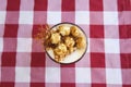 Glass of coffee latte with whipped cream, caramel popcorn, cinnamon and salty caramel on table, top view Royalty Free Stock Photo