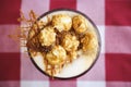 Glass of coffee latte with whipped cream, caramel popcorn, cinnamon and salty caramel on table, top view Royalty Free Stock Photo