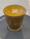 Glass of Coffee Piccolo Latte on a wooden table Sydney Melbourne Australia