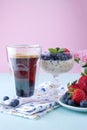 A glass of coffee and pudding chia with blueberries and strawberries for breakfast. Vegetarian food. A small bouquet of flowers, a Royalty Free Stock Photo