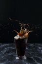 A glass of coffee, coffee splash