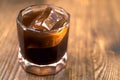 A glass of coffee on wooden background. Iced americano in cafe. Cool summer drinks. Whiskey coctail, coffee-based alcohol Royalty Free Stock Photo