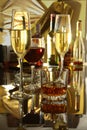 Glass of cognac, brandy or whiscy on mirror table. bottles in a bar on the background Royalty Free Stock Photo