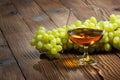 Glass of cognac and bunch of grapes