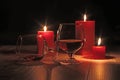 Glass of cognac and red candle on a wooden background Royalty Free Stock Photo