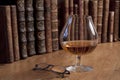 Glass of cognac and vintage books Royalty Free Stock Photo