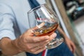 A Glass of Cognac in a Waiter`s Hand