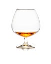 Glass of cognac or whiskey on white Royalty Free Stock Photo