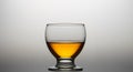 Glass of cognac or whiskey over gradients light background