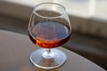 glass of cognac on a wooden table in the bar Royalty Free Stock Photo