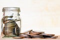 Glass of coin and spread coin on floor on vintage wood blurred b Royalty Free Stock Photo