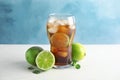 Glass of coke with ice cubes and limes on table Royalty Free Stock Photo